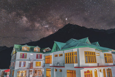 Residential buildings against sky at night