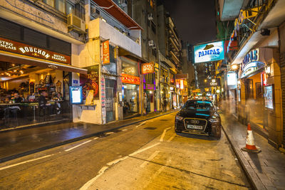 Cars on city street at night