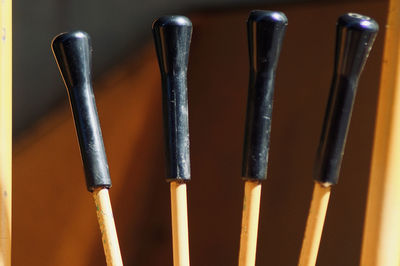 Close-up of industrial objects against yellow background