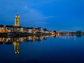 Reflection of illuminated buildings in city at night