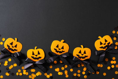 High angle view of yellow pumpkins against black background