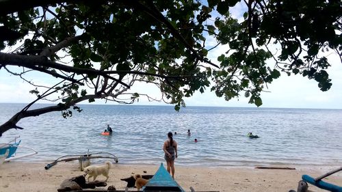 People on beach against sky