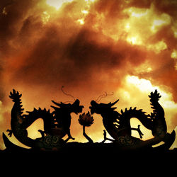 Low angle view of statue against cloudy sky