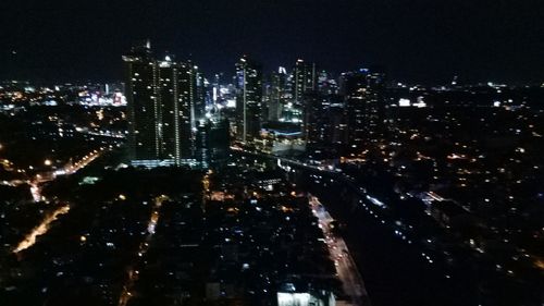 Aerial view of city lit up at night