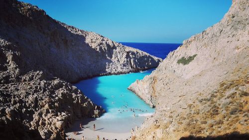 Panoramic view of sea and mountains against clear blue sky