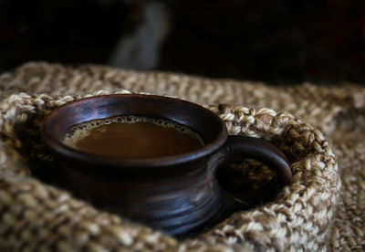 Close-up of coffee in cup amidst scarf