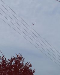 Low angle view of airplane flying in sky