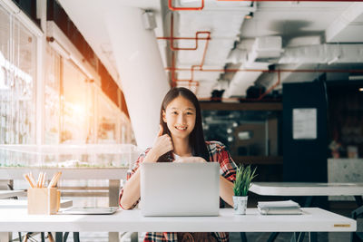 Portrait of woman working on table