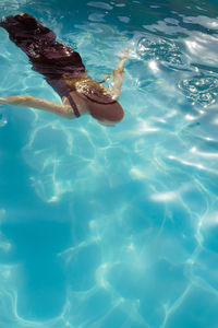 High angle view of woman swimming in sea