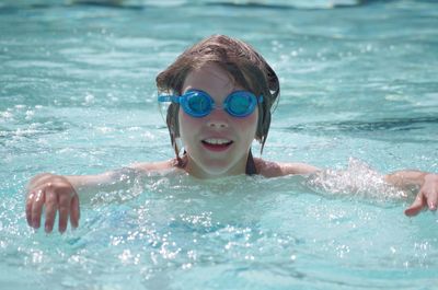 Portrait of girl swimming in pool