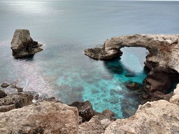 High angle view of rocks on sea shore