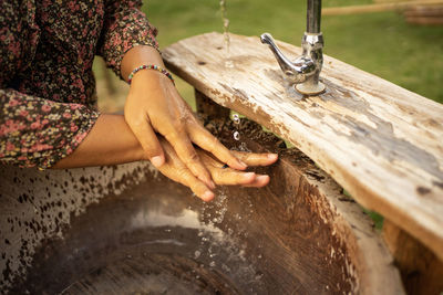 Women wash their hands with clean water all over their hands to cleanse germs.