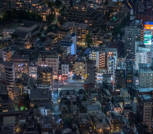 High angle view of city lit up at night