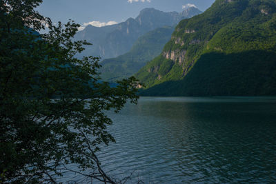 Scenic view of river and mountains against sky