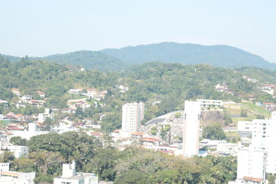 Scenic view of trees and mountains against clear sky