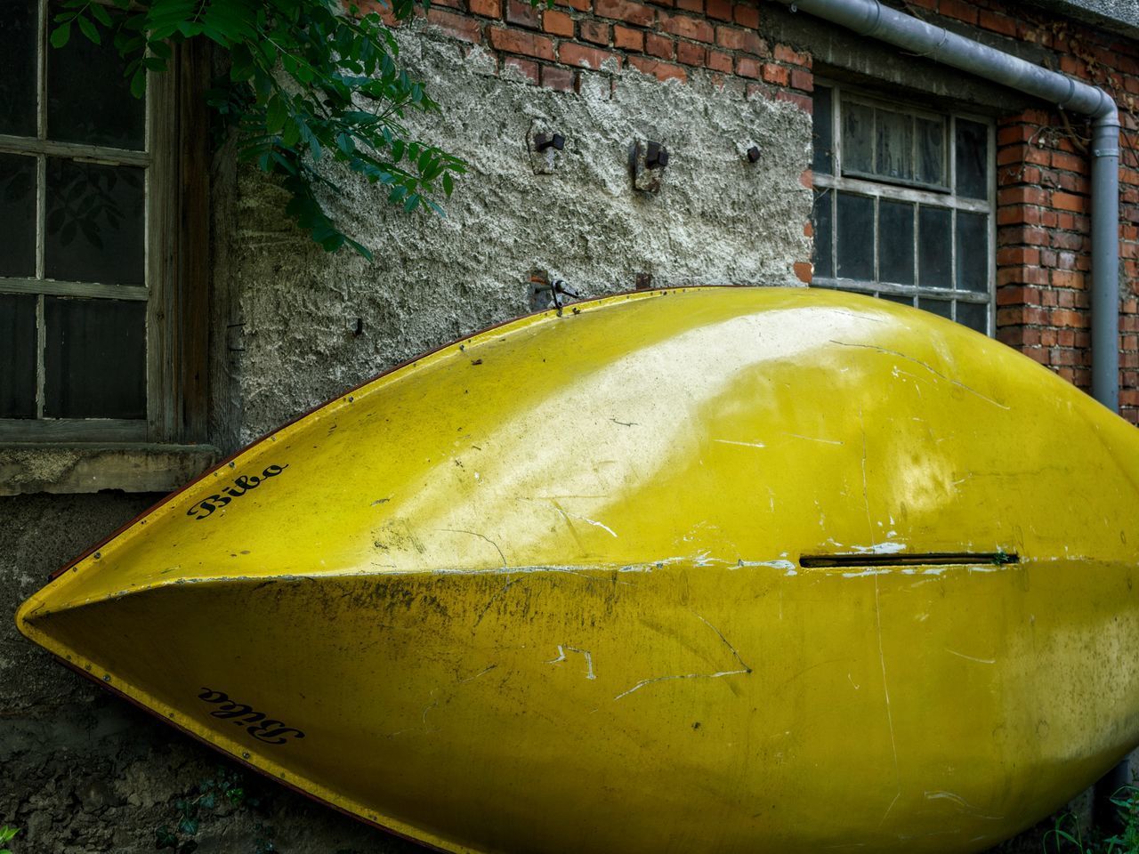 CLOSE-UP OF YELLOW WINDOW ON BUILDING