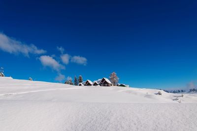 Scenic view of snowcapped mountains against blue sky