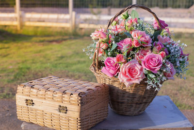 Close-up of rose bouquet in basket on table