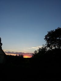 View of trees against sky at sunset