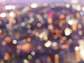 Defocused image of illuminated city at dusk