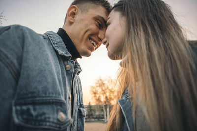 Stunning sensual young couple in love posing at the sunset, happy lifestyle concept