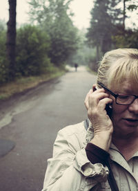 Cropped image of woman talking on mobile phone at street