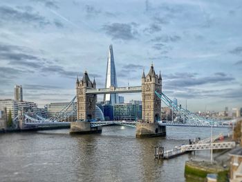 View of bridge over river against cloudy sky