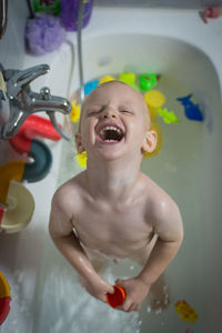 Portrait of cute baby boy in bathroom