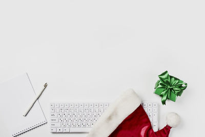 Low section of woman with christmas decorations on white background