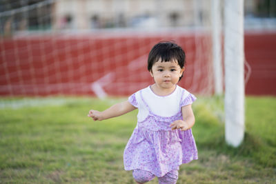 Full length of cute girl on field