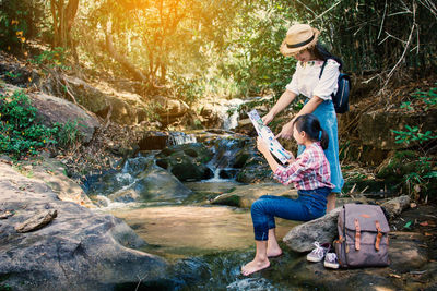Full length of a young woman in forest