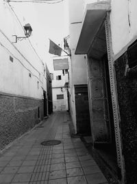 Road amidst buildings against sky