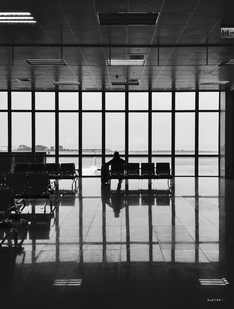 indoors, window, glass - material, airport, men, modern, built structure, architecture, lifestyles, transparent, silhouette, transportation, person, reflection, office, flooring, travel, sitting