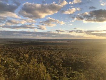 Scenic view of field against sky during sunset