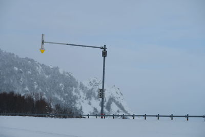 Snow covered field against sky