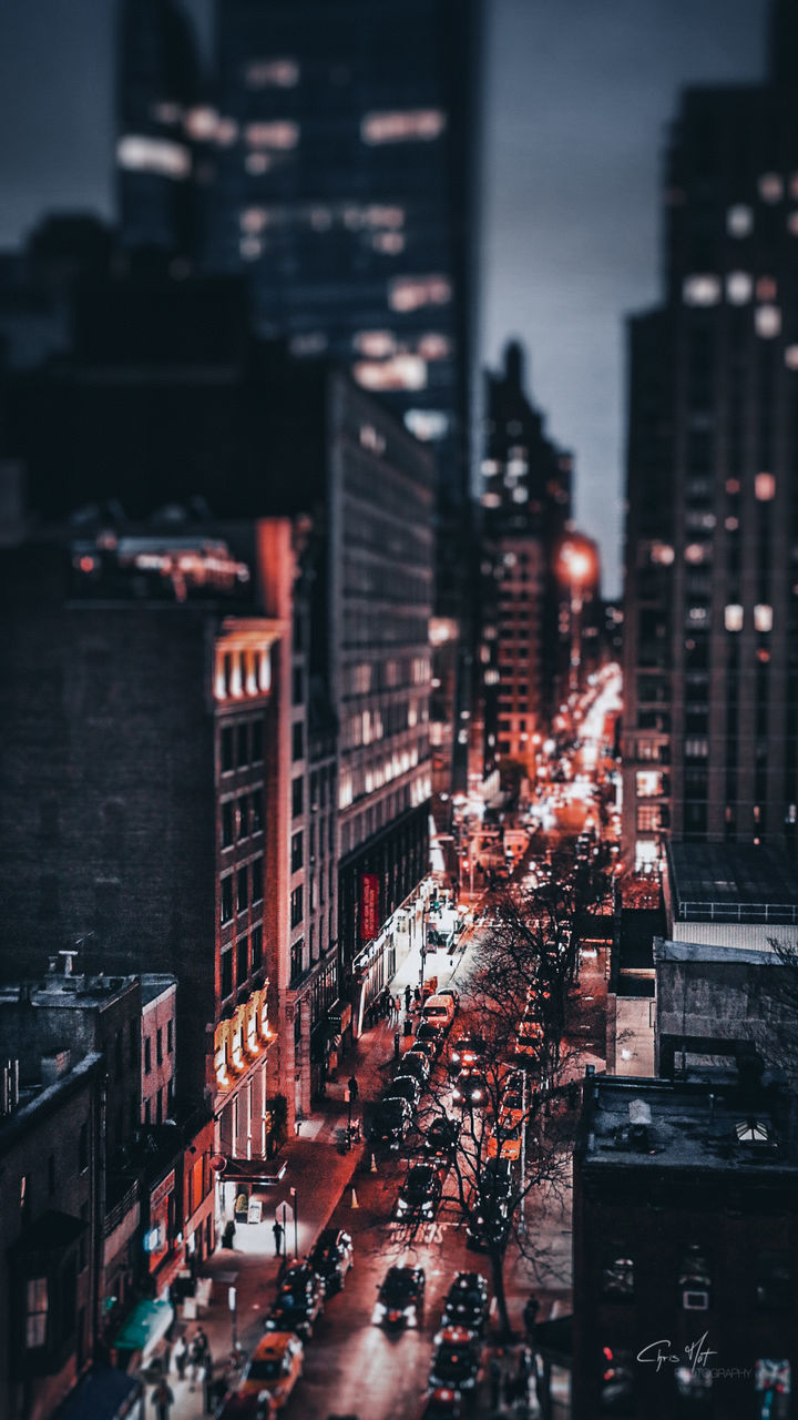 HIGH ANGLE VIEW OF TRAFFIC ON CITY STREET AND BUILDINGS