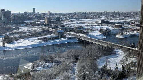 High angle view of river amidst buildings in city