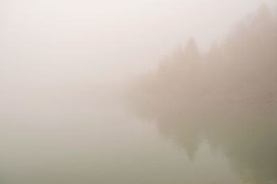 Scenic view of fog against sky at morning