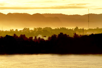 Scenic view of lake against sky during sunset