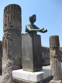 Low angle view of statue against clear blue sky