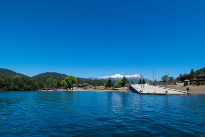 View of calm sea against clear blue sky