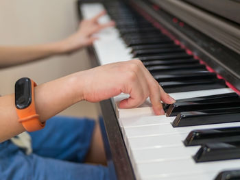 Midsection of person playing piano