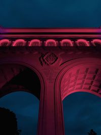 Low angle view of illuminated building against sky