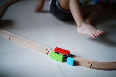 High angle view of child playing with toy on floor at home