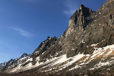 Low angle view of snowcapped mountain against sky