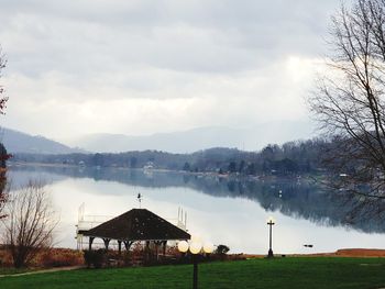 Built structure by lake against sky