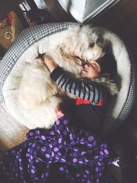 High angle view of woman sleeping in animal pen