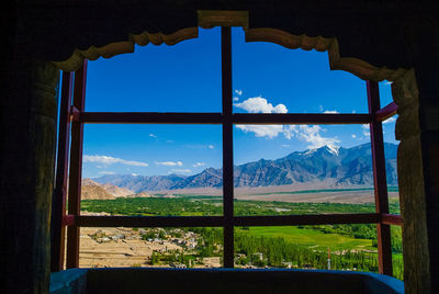 Scenic view of landscape seen through window