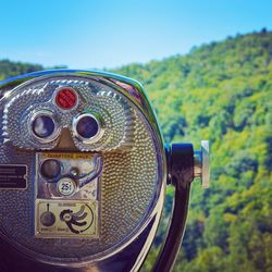 Close-up of coin-operated binoculars against sky