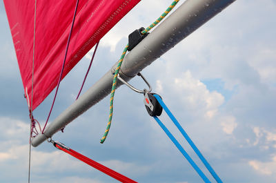 Low angle view of flags hanging against sky